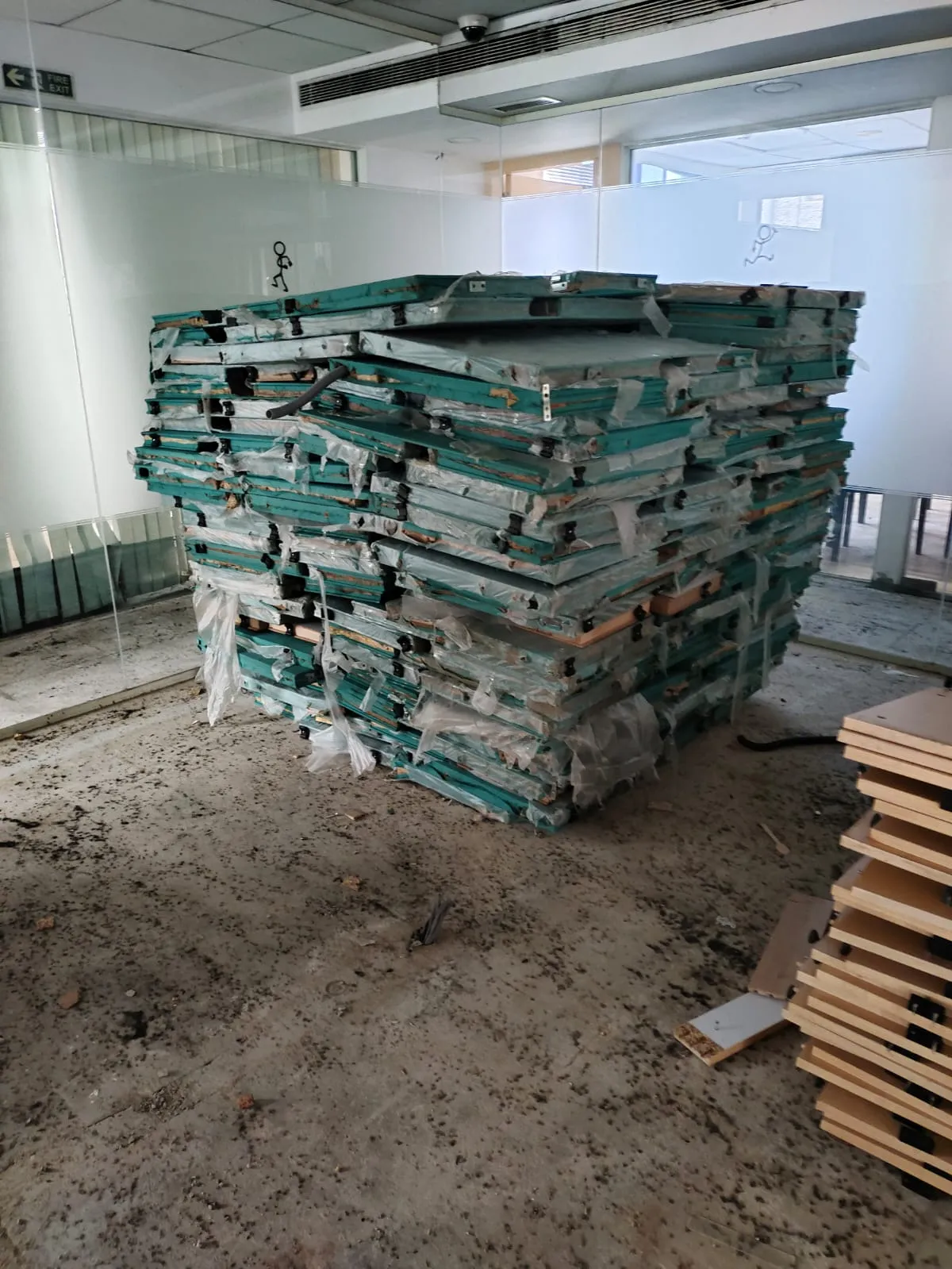 Stacked modular workstation panels and office partition sections collected during a commercial office strip out service in Bangalore.